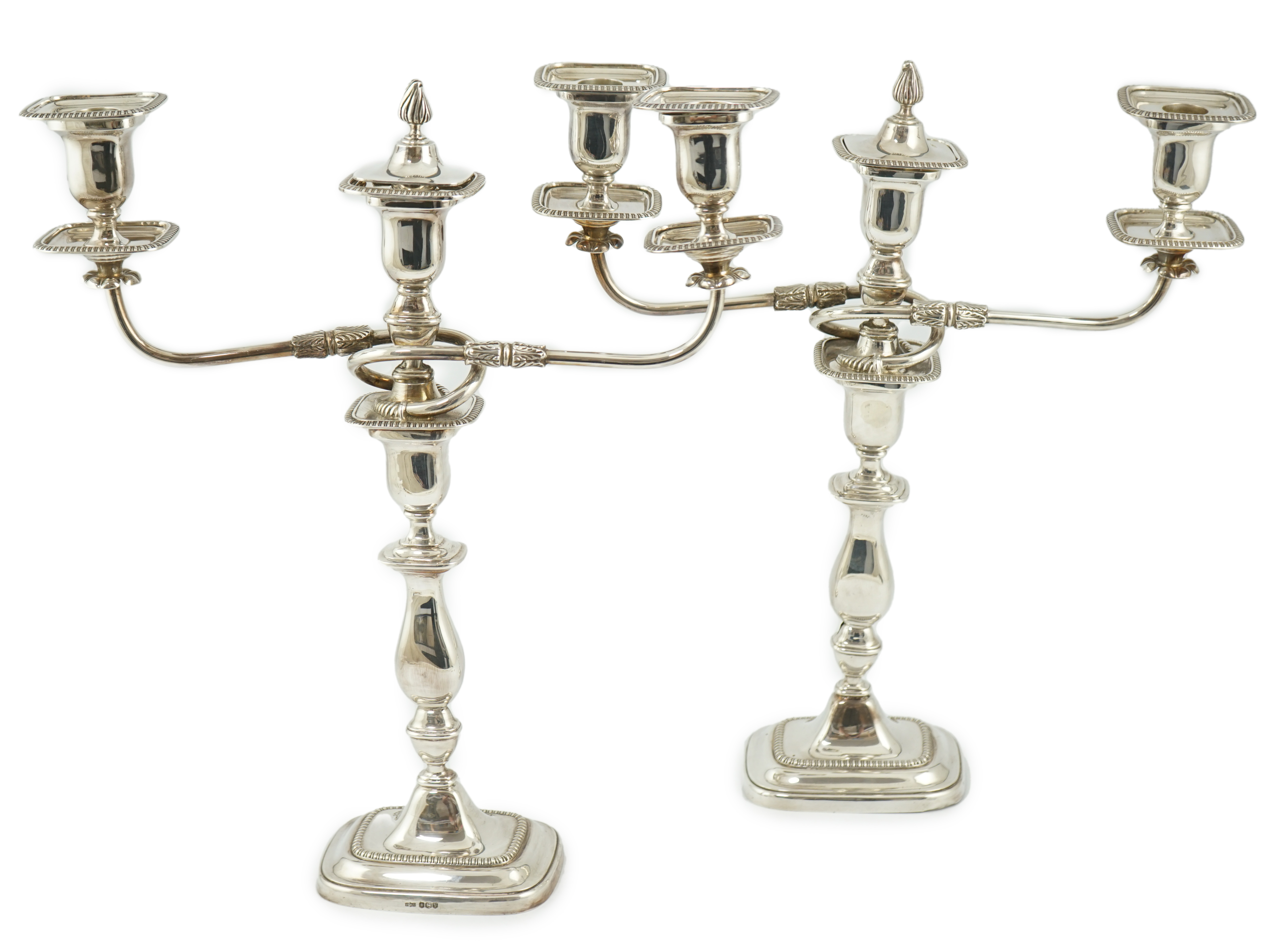 A pair of Elizabeth II silver two branch two light candelabra, by James Dixon & Sons